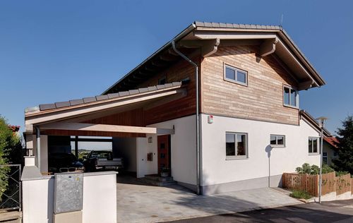 Modernes Holzhaus im Landhausstil auf einem Hanggrundstück